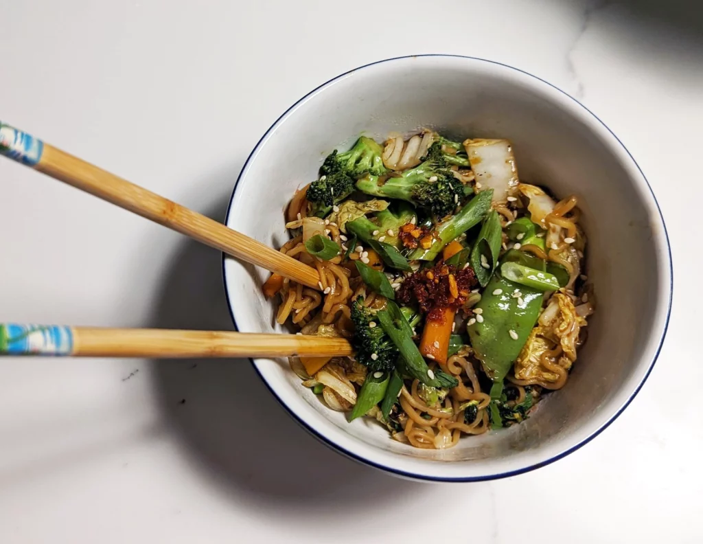 Spicy Garlic Cabbage and Vegetable Stir Fry in a bowl with chopsticks